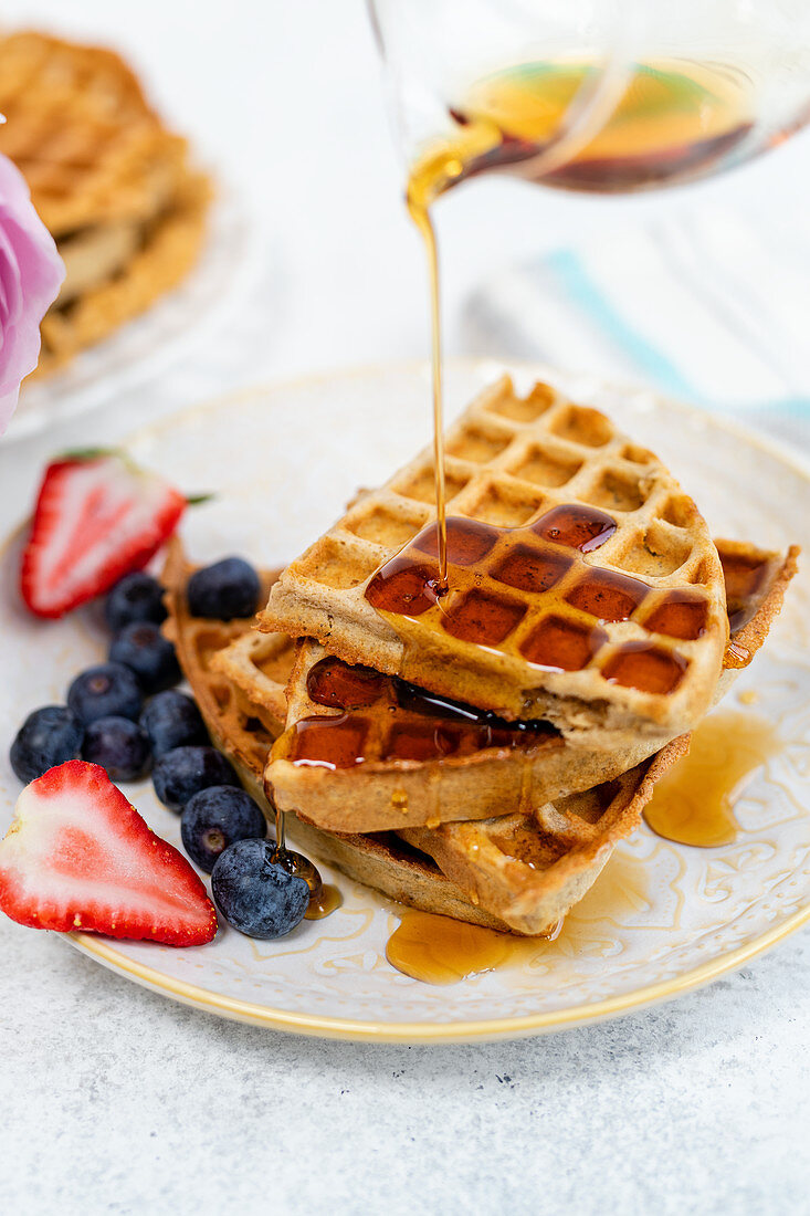 Healthy breakfast waffles with maple syrup