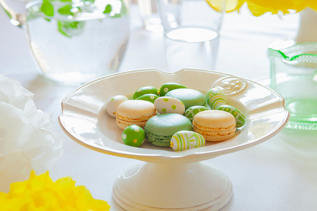 Macaroons and painted mini Easter eggs on a spring-themed Easter table