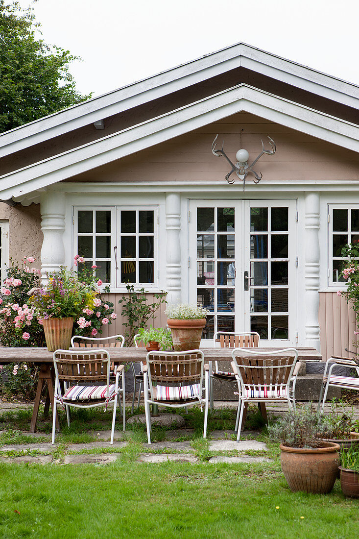 Table and chairs on terrace outside rustic country house