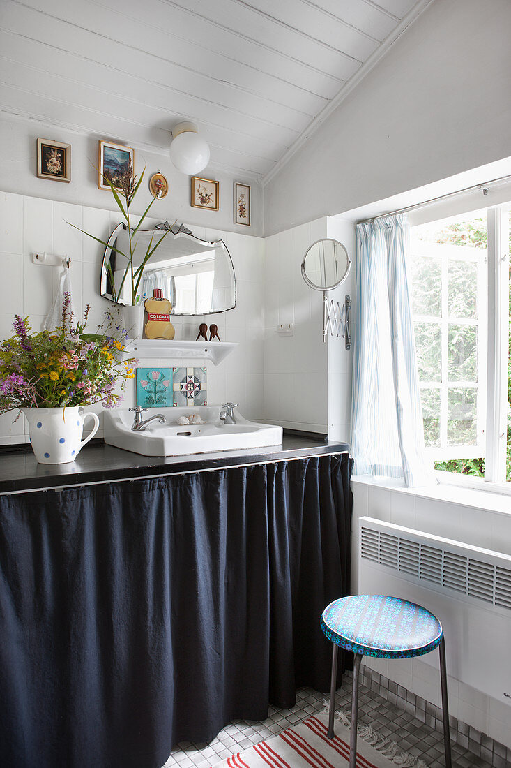 Washstand with dark curtain cover in shabby-chic bathroom