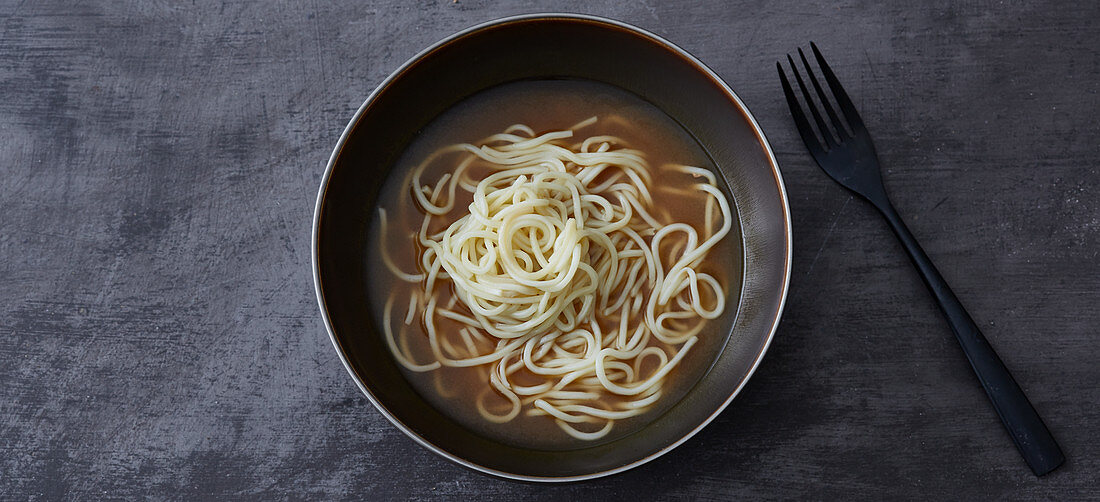 Ramen being served – noodles being added