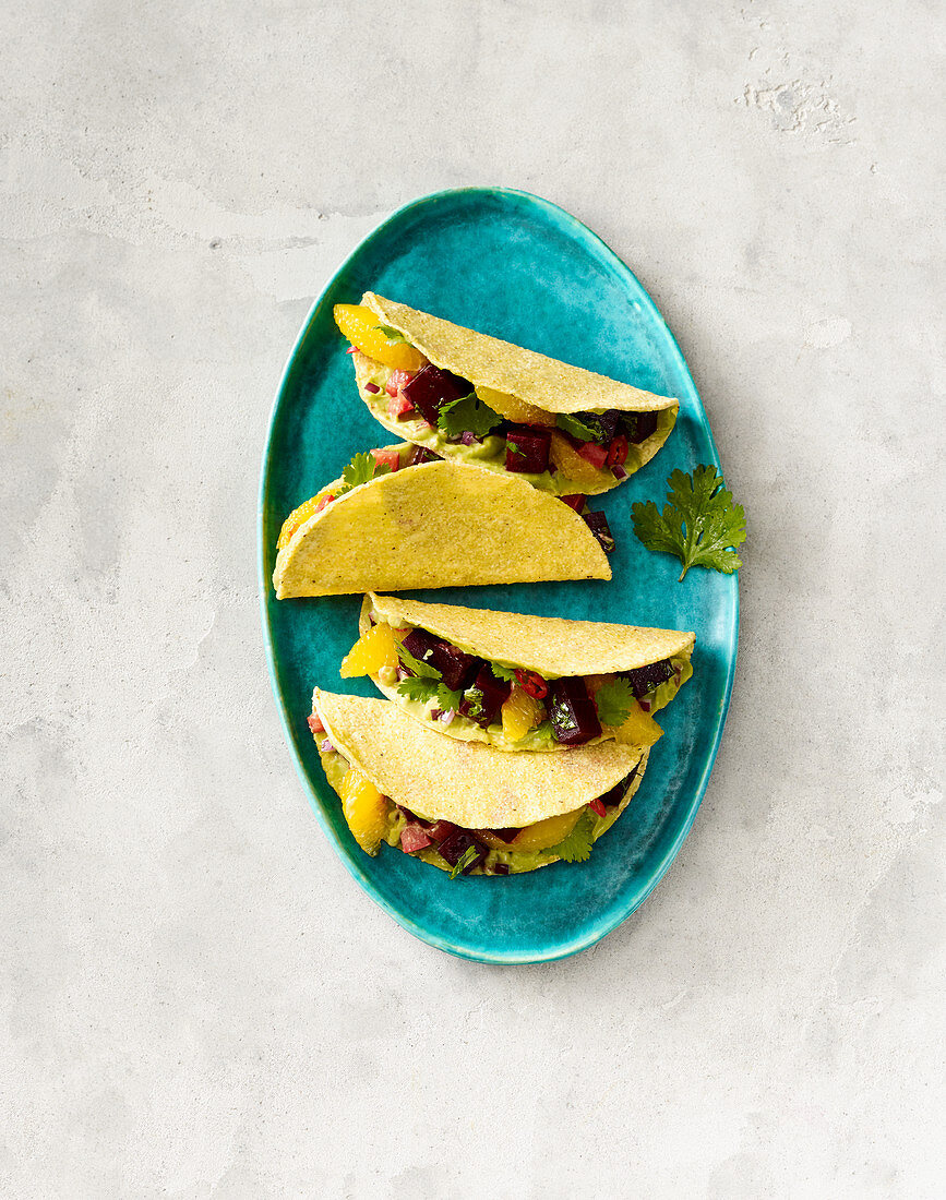 Vegan tacos with beetroot, oranges and guacamole
