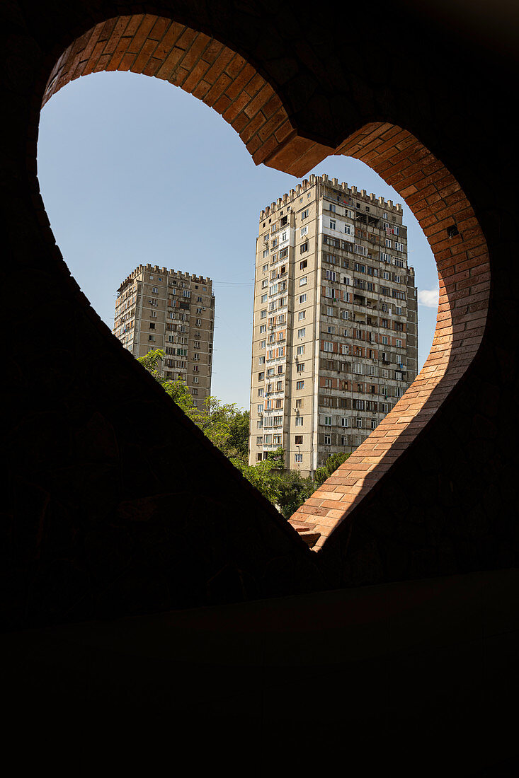 A view through a heart-shaped peephole of a tower block, Soviet district, Tbilisi, Georgia