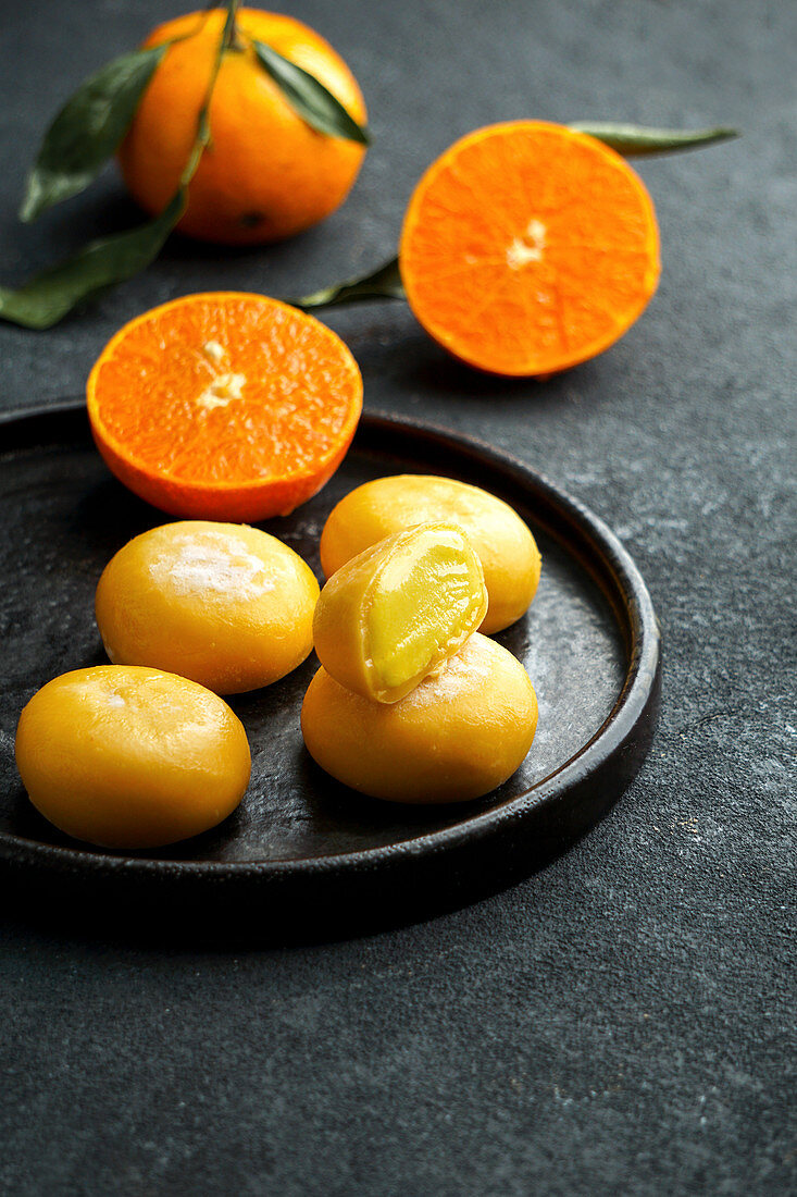 Mochi ice cream with tangerine (traditional Japanese rice sweets)
