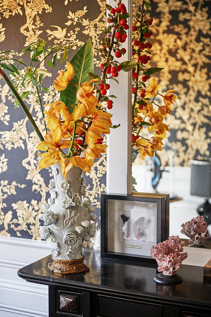 Flowers in opulent vase with sculpted flower motifs