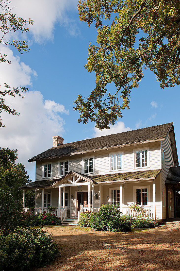 Wooden house in American country-house style with veranda