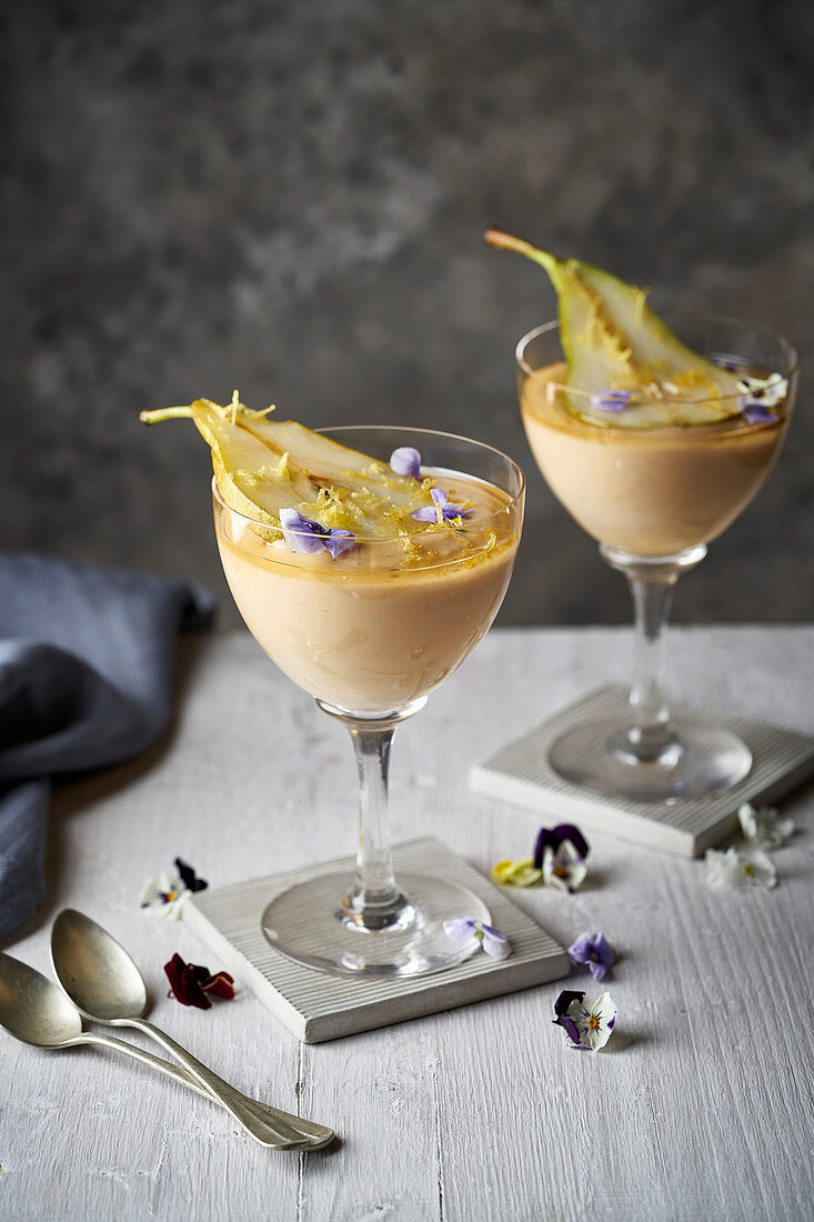 Pear custard dessert with edible flowers