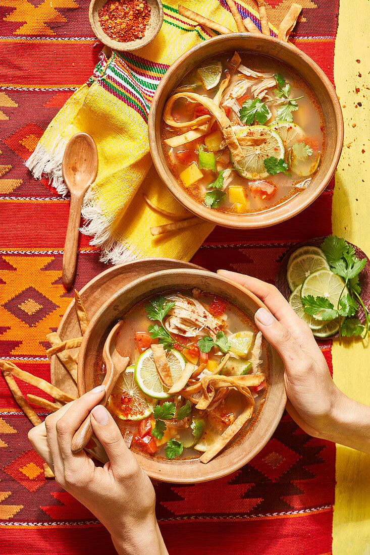 Mexican soup with tortillas and lime