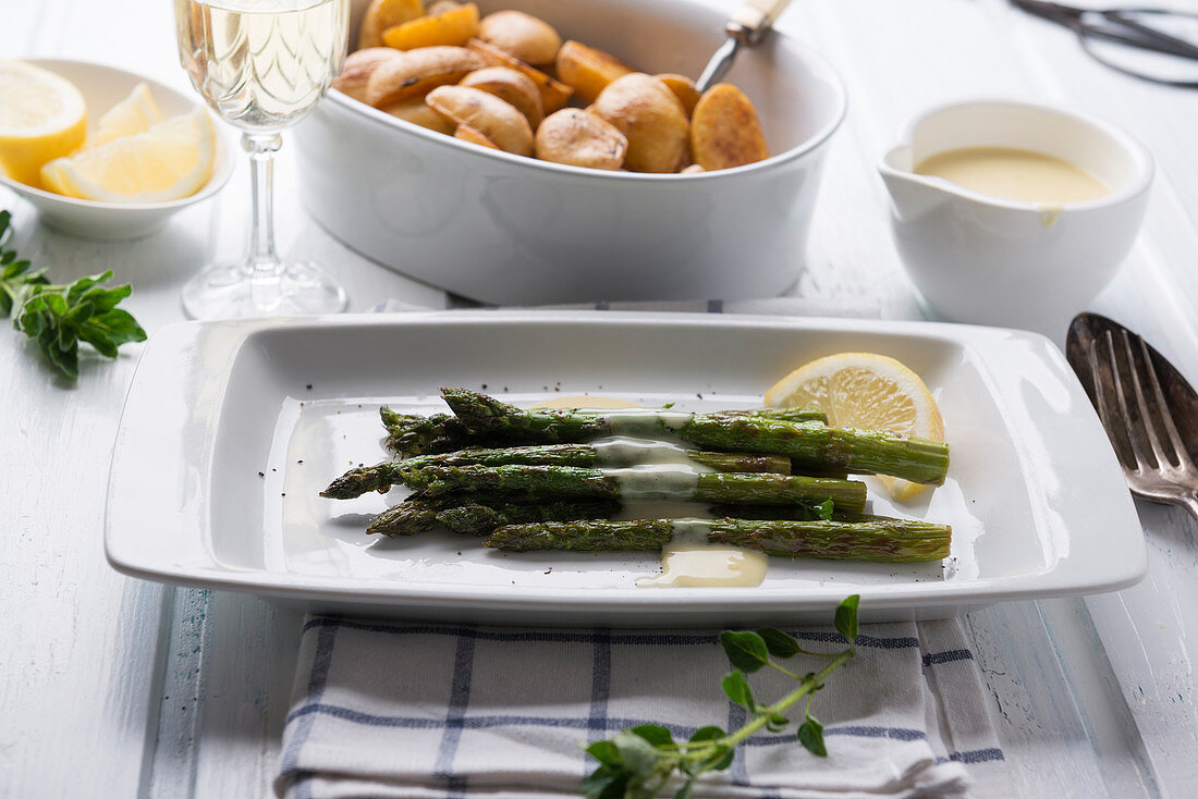 Grilled green asparagus with vegan Sauce Hollandaise with mini roast potatoes