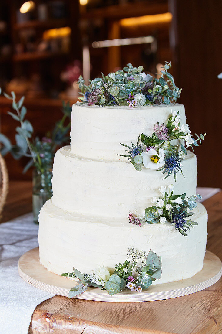 A three-tier wedding cake decorated with flowers