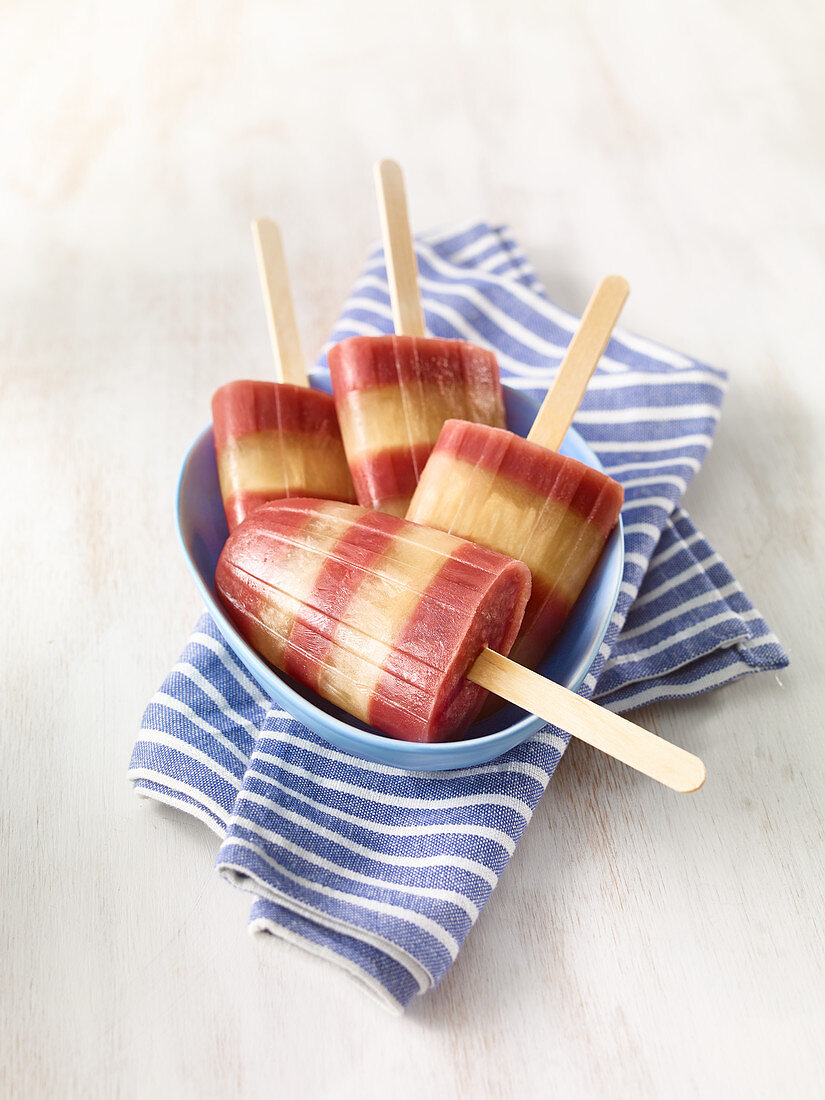 Striped apple and pomegranate ice lollies