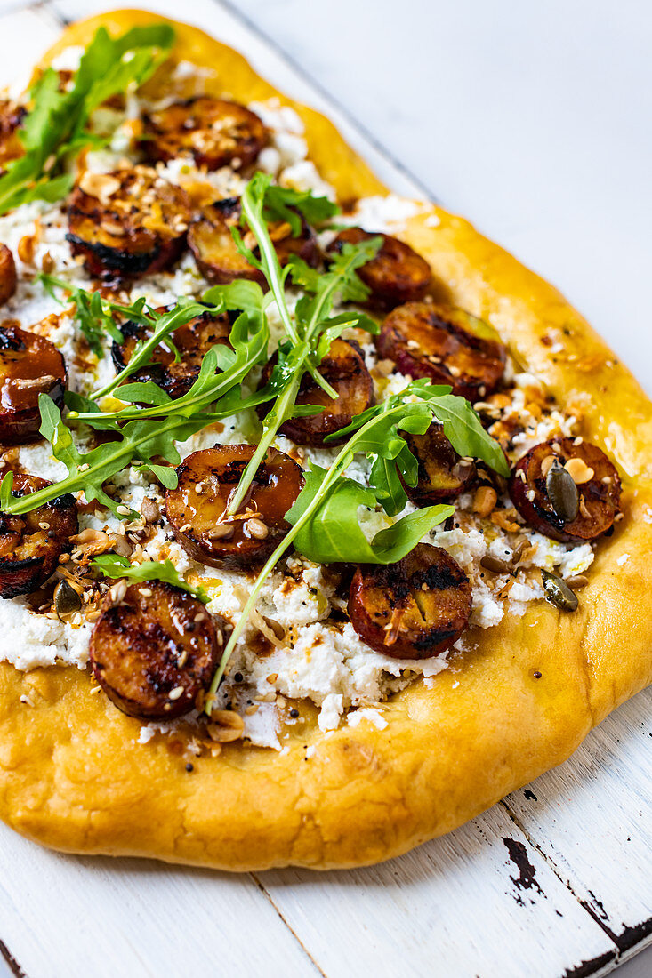 Unleavened bread topped with feta cheese and rocket