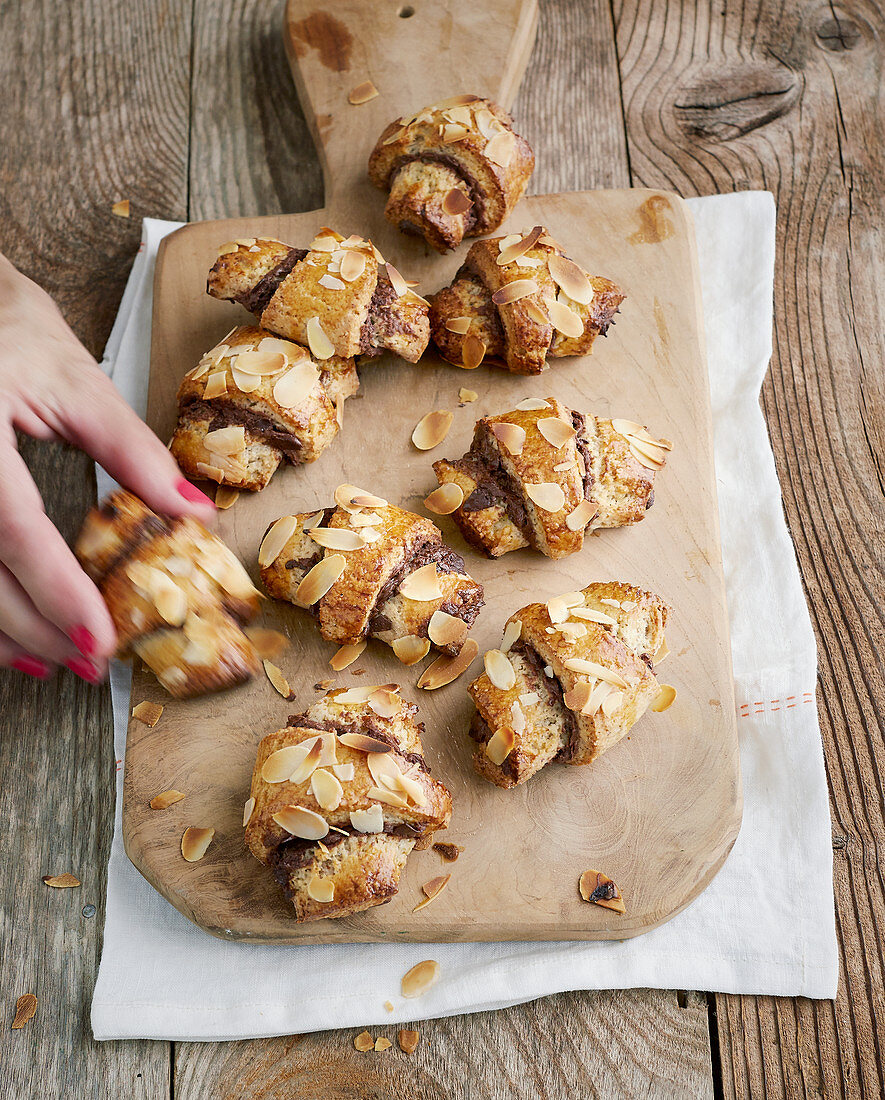 Almond croissants with chocolate cream on a wooden board