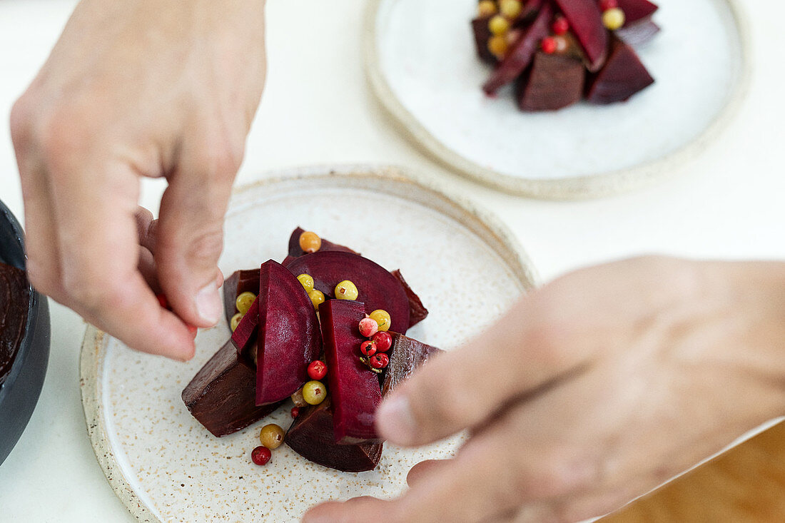 A beetroot dish being plated