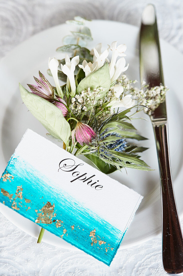 Small plate bouquet made of waxflower, star umbel, eucalyptus, gypsophila, and Eryngo