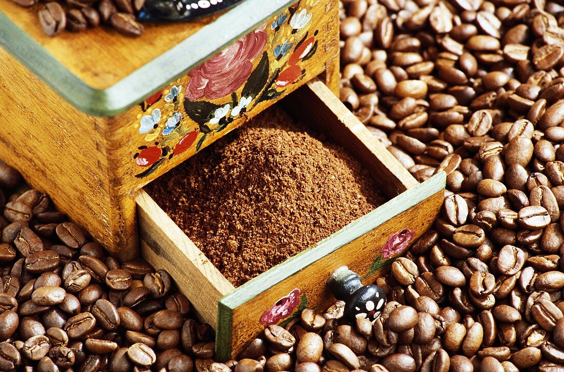 Ground coffee in the drawer of an old coffee mill