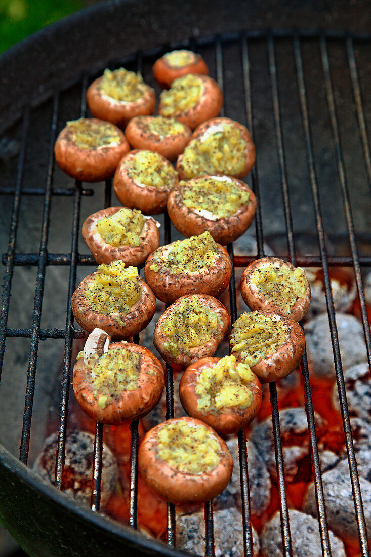 Mushrooms with potato and pesto filling on a grill rack