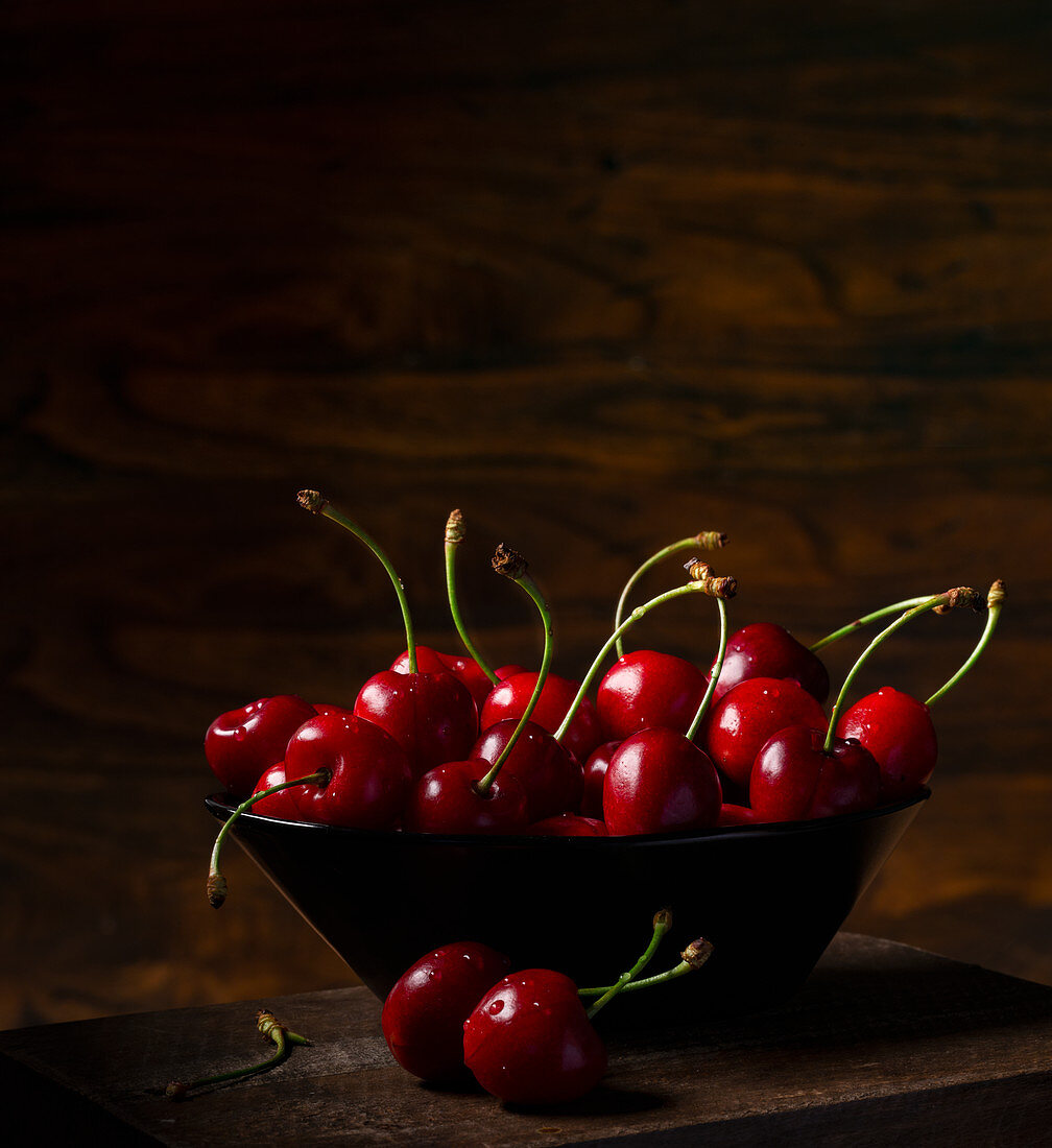 Cherries in a bowl against a dark background