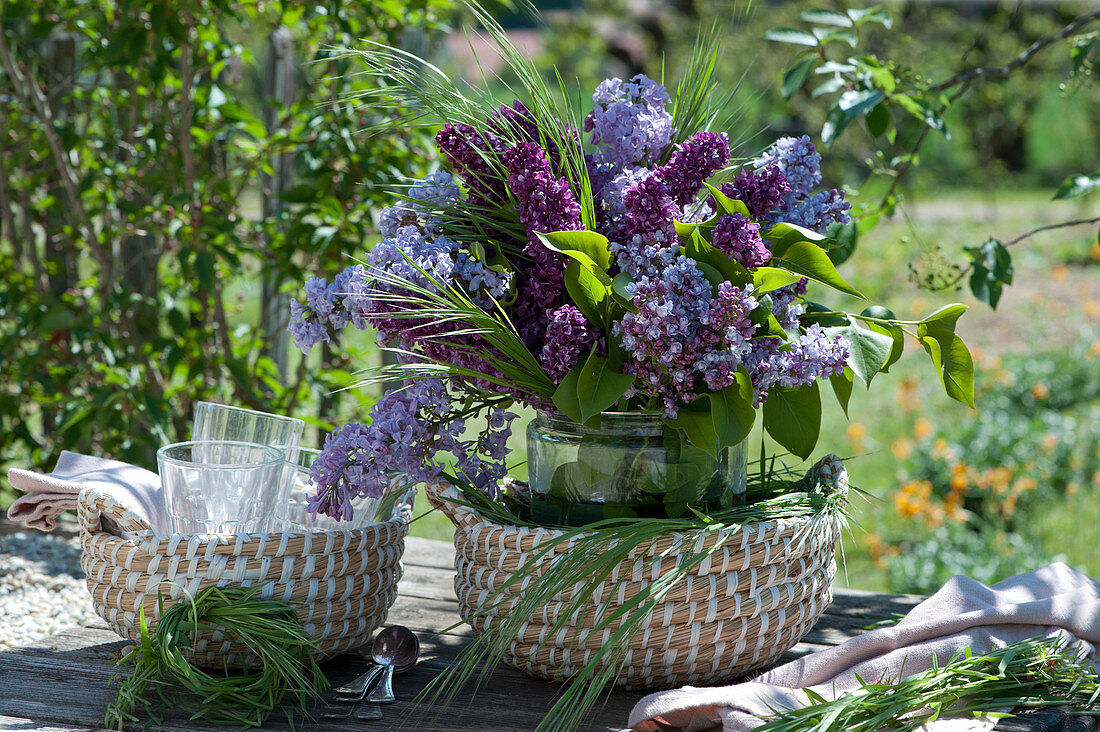 Lilacs bouquet mixed light and dark with grasses