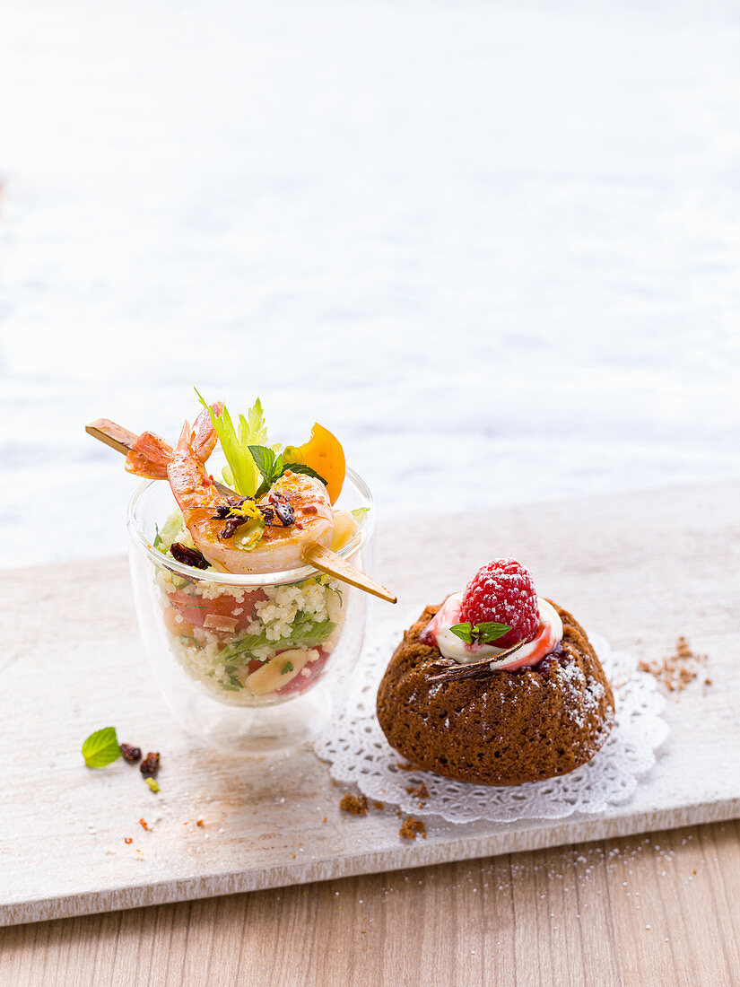 Salad in a glass and a mini ring cake with raspberry