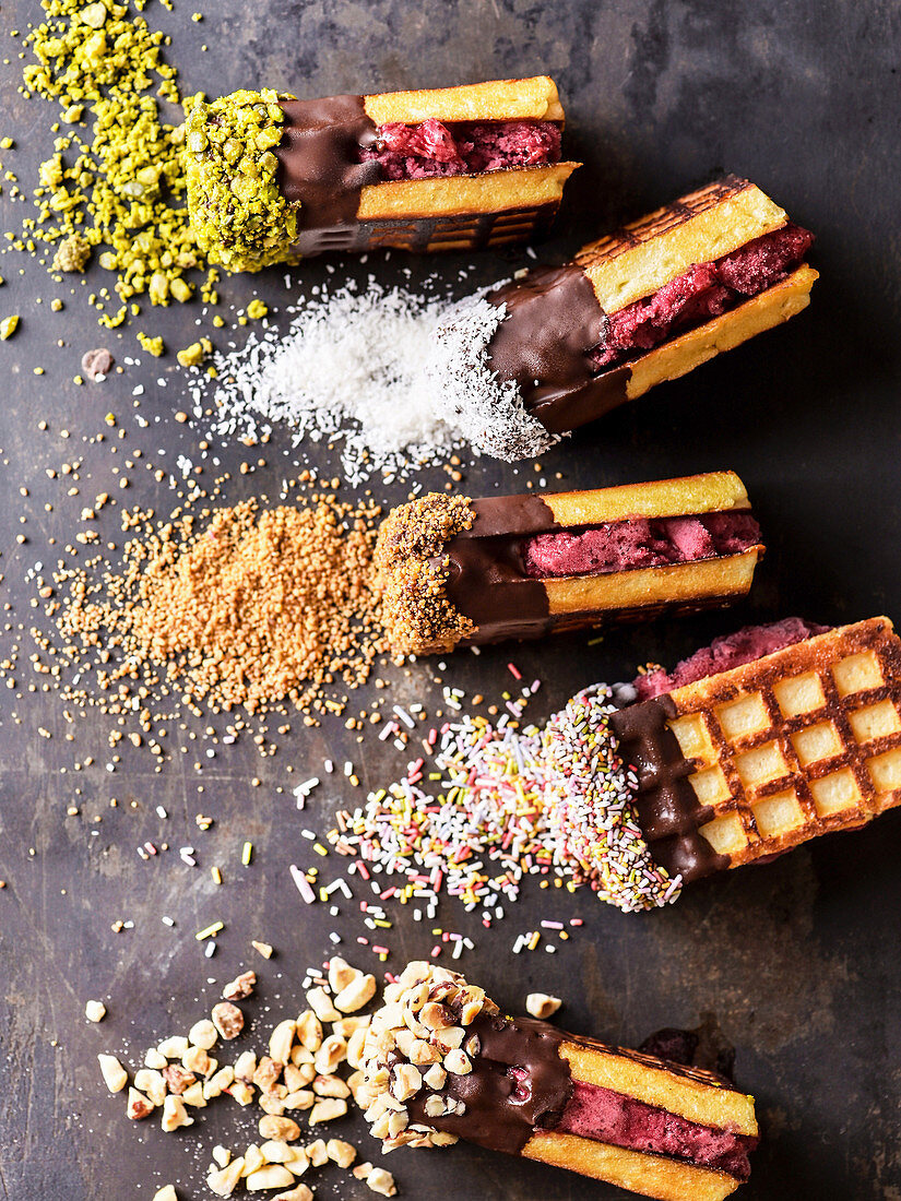 Waffle ice cream sandwiches with raspberry sorbet and various toppings