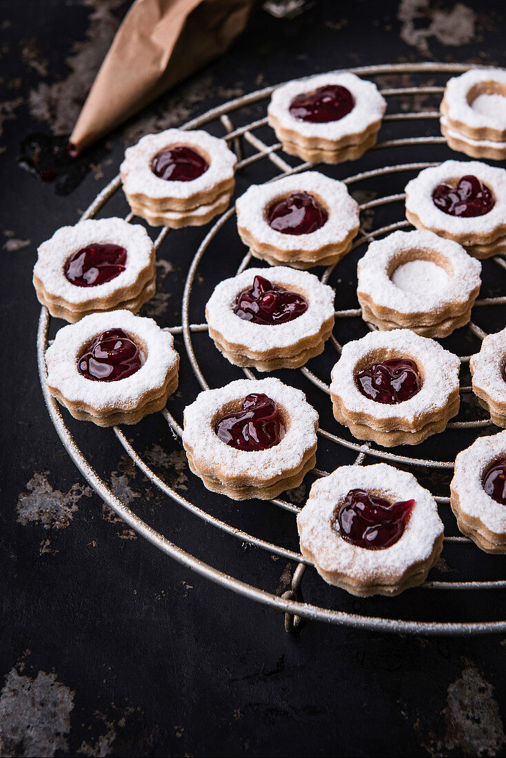 Linzer cookies with currant jelly on a cooling rack