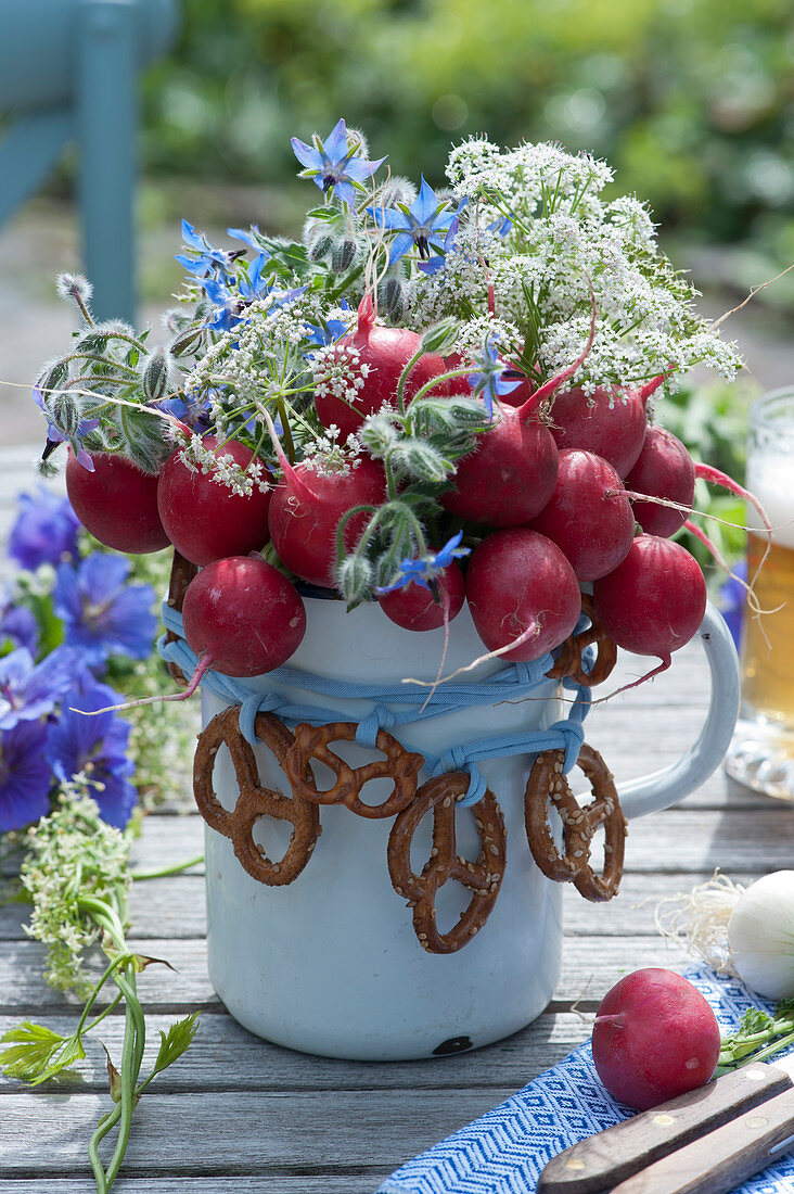 Edible bouquet made from radishes, borage and beaver nelle, decorated with pretzels