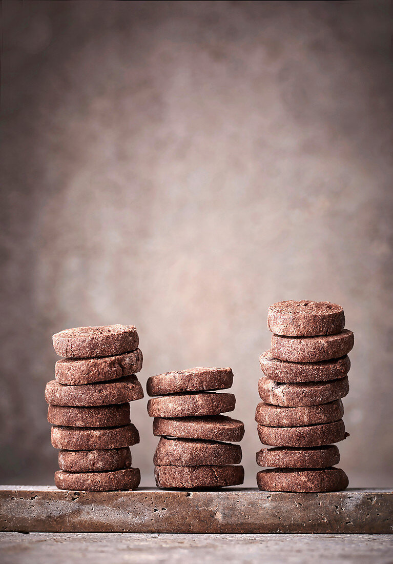 Stacked chocolate cookies on a stone plate