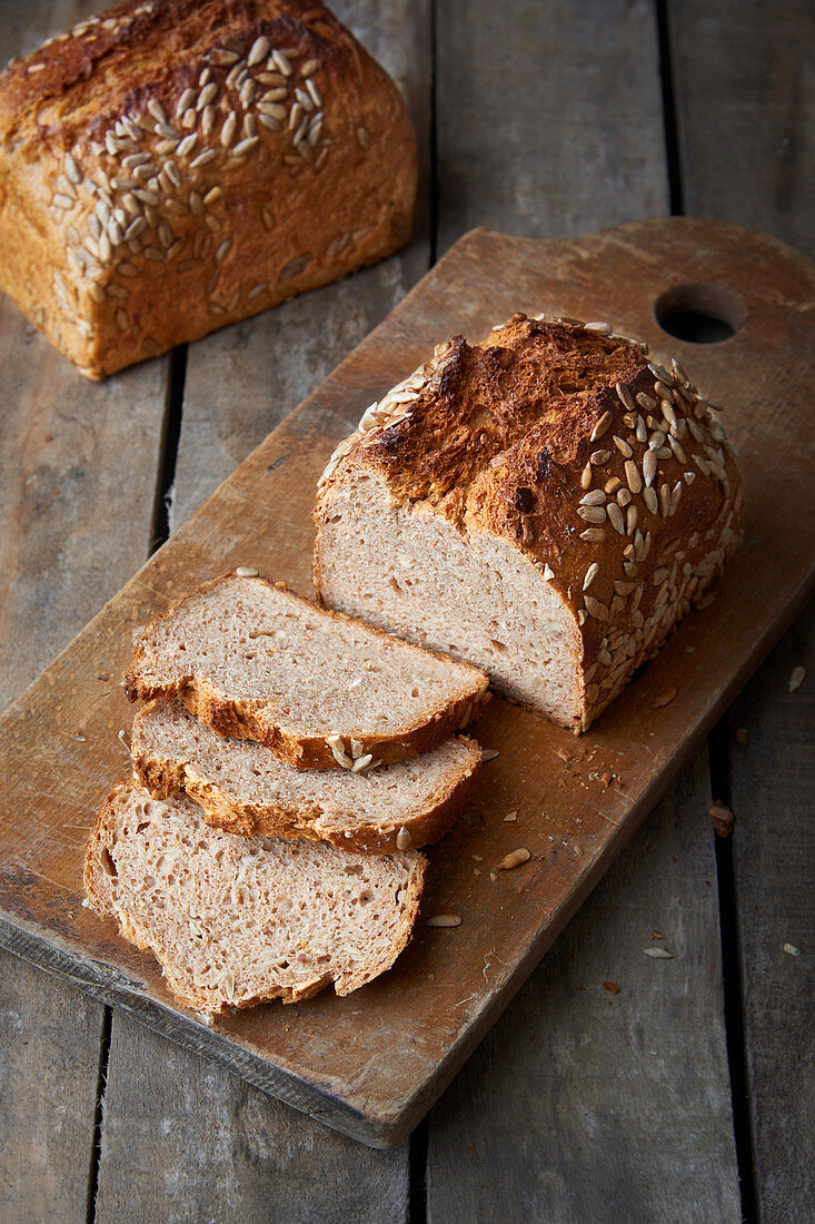 Wholemeal spelt bread sliced on a wooden board