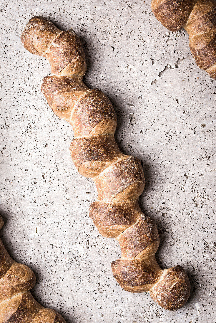 Three baguettes in a zigzag shape on a stone slab