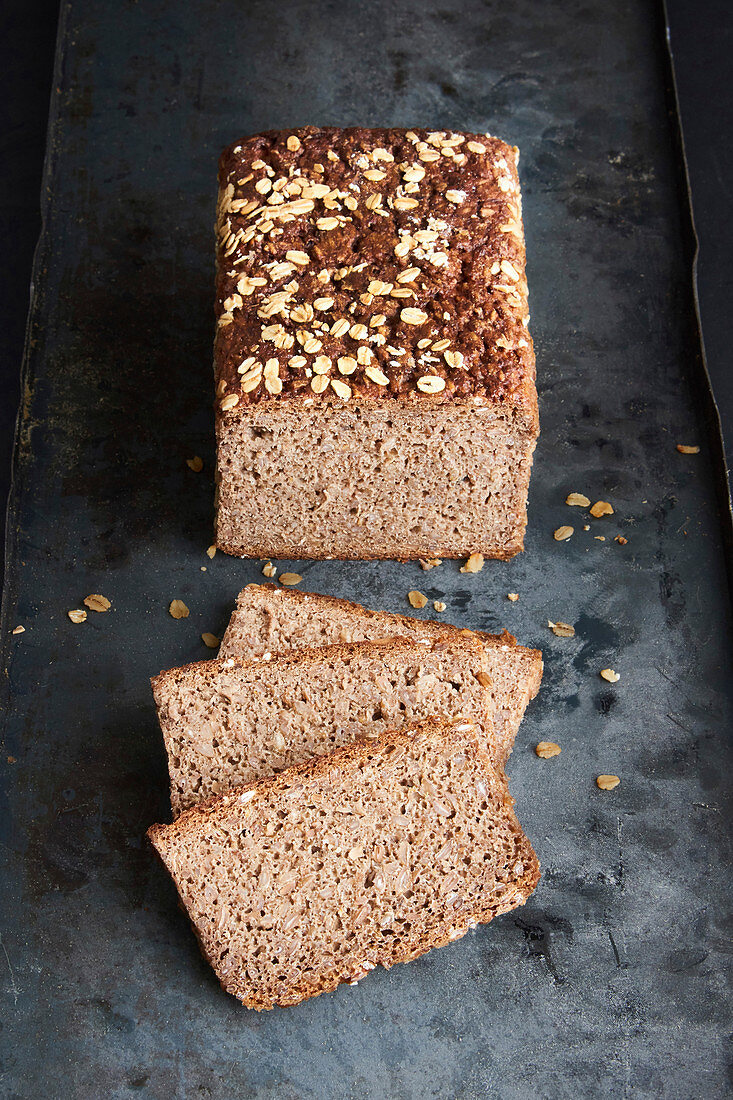 Whole grain bread with linseed and oatmeal on a baking sheet