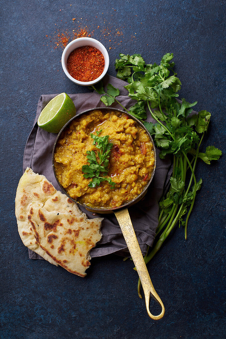 Vegan Indian red lentil curry soup dal with rice naan