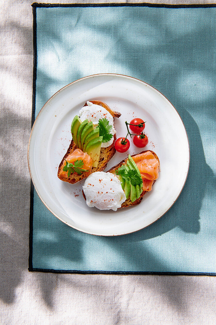 Bread topped with smoked salmon, avocado and poached eggs