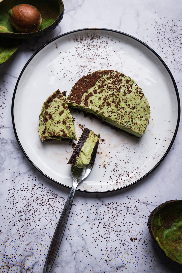 Vegan raw food avocado cake with date and nut base