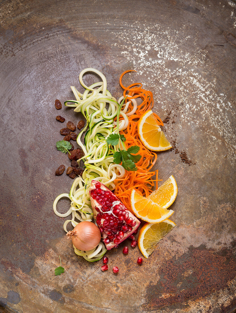 Coodles and zoodles with pomegranate, coriander, oranges, raisins and onions