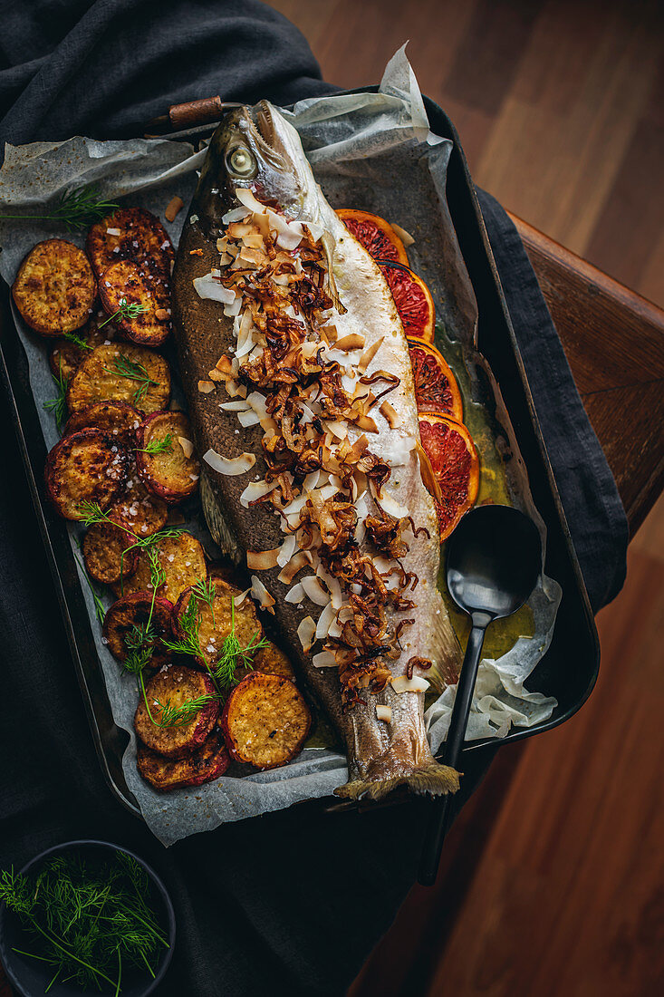 Whole baked rainbow trout with garlic and dill butter, lemongrass and crispy shallots