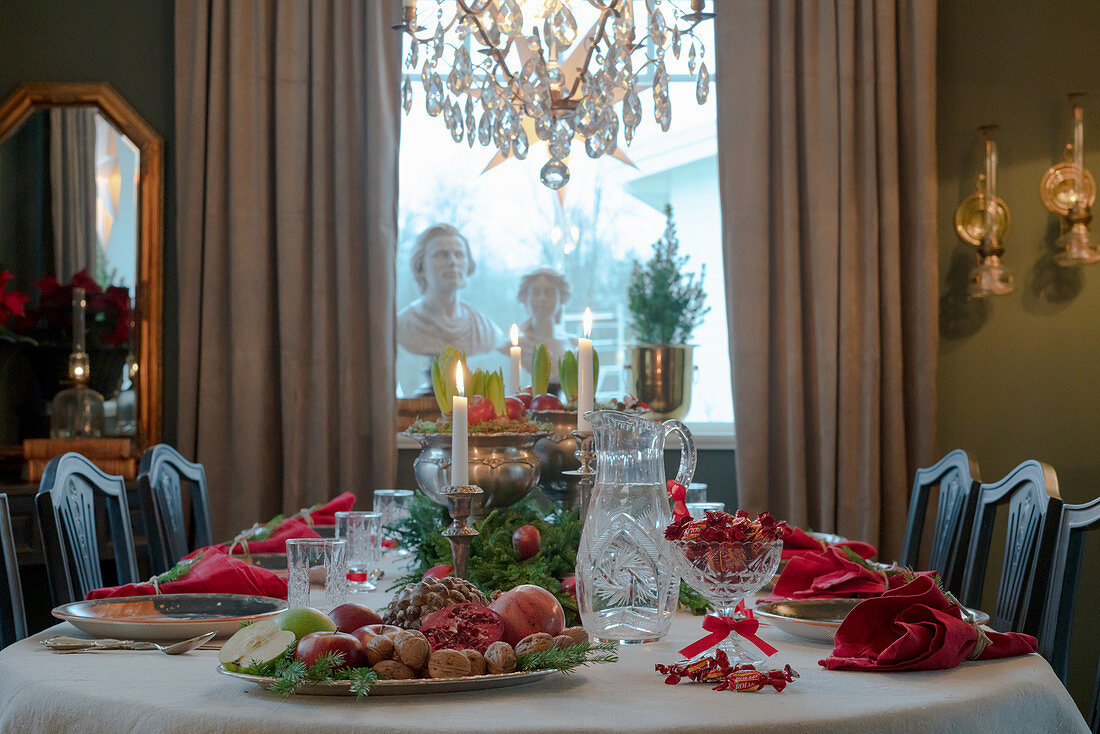 Festively set table in classic dining room decorated for Christmas