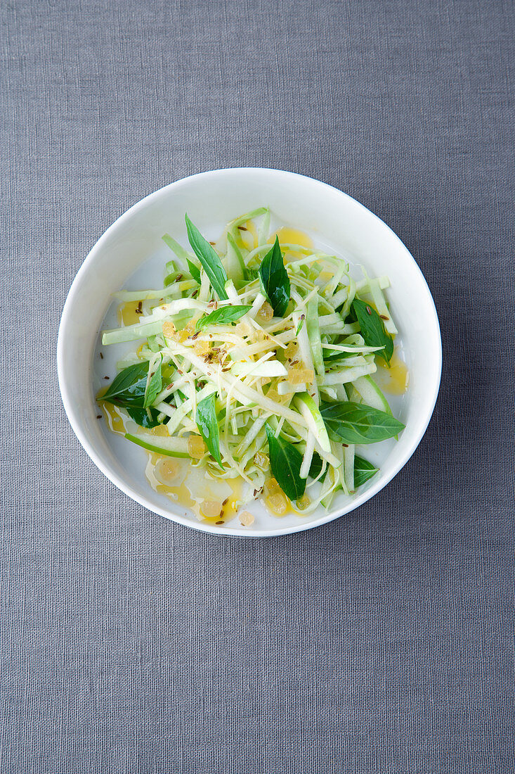 White cabbage and apple salad with cumin and Thai basil