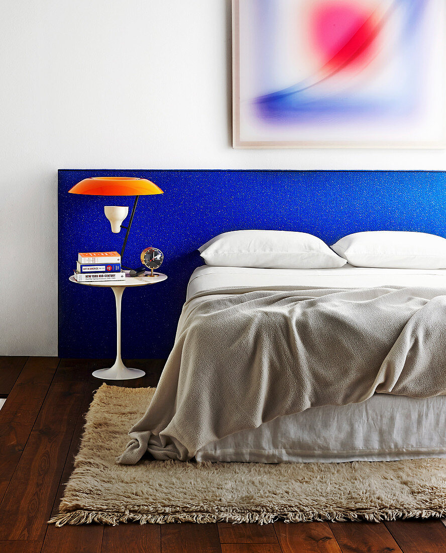Double bed with headboard upholstered in blue fabric
