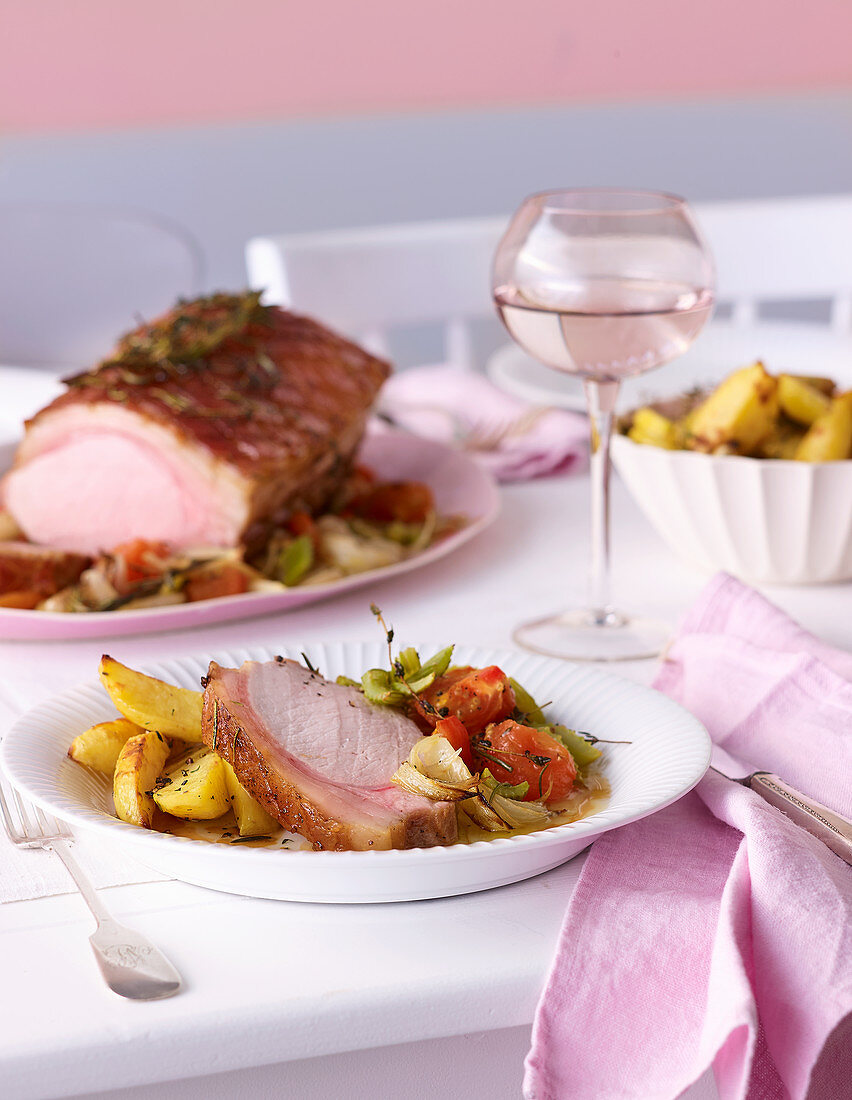 Roast pork Toscana with roasted potatoes and bean salad