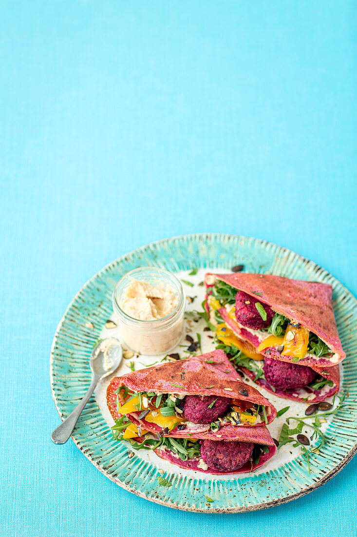 Beetroot pancakes with hummus and beetroot no-meatballs