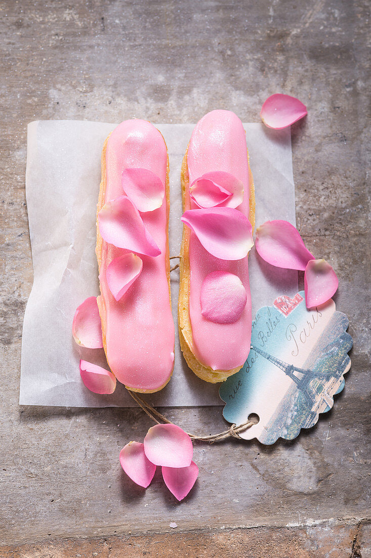 Eclairs with rose cream and rose petals