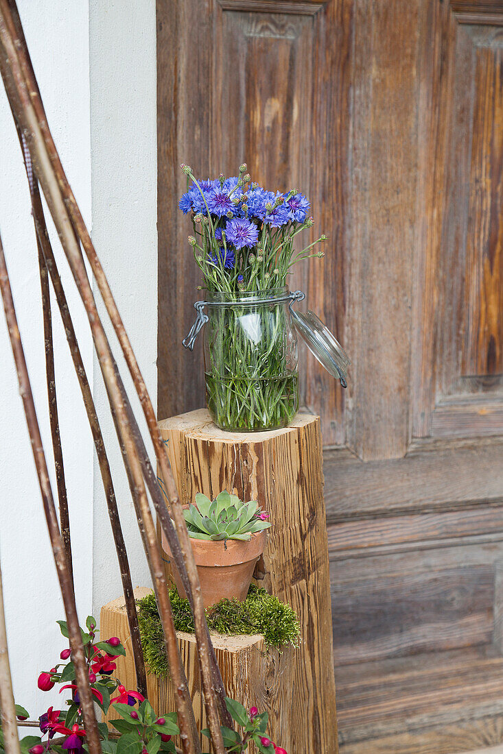 Bunch of cornflowers in preserving jar