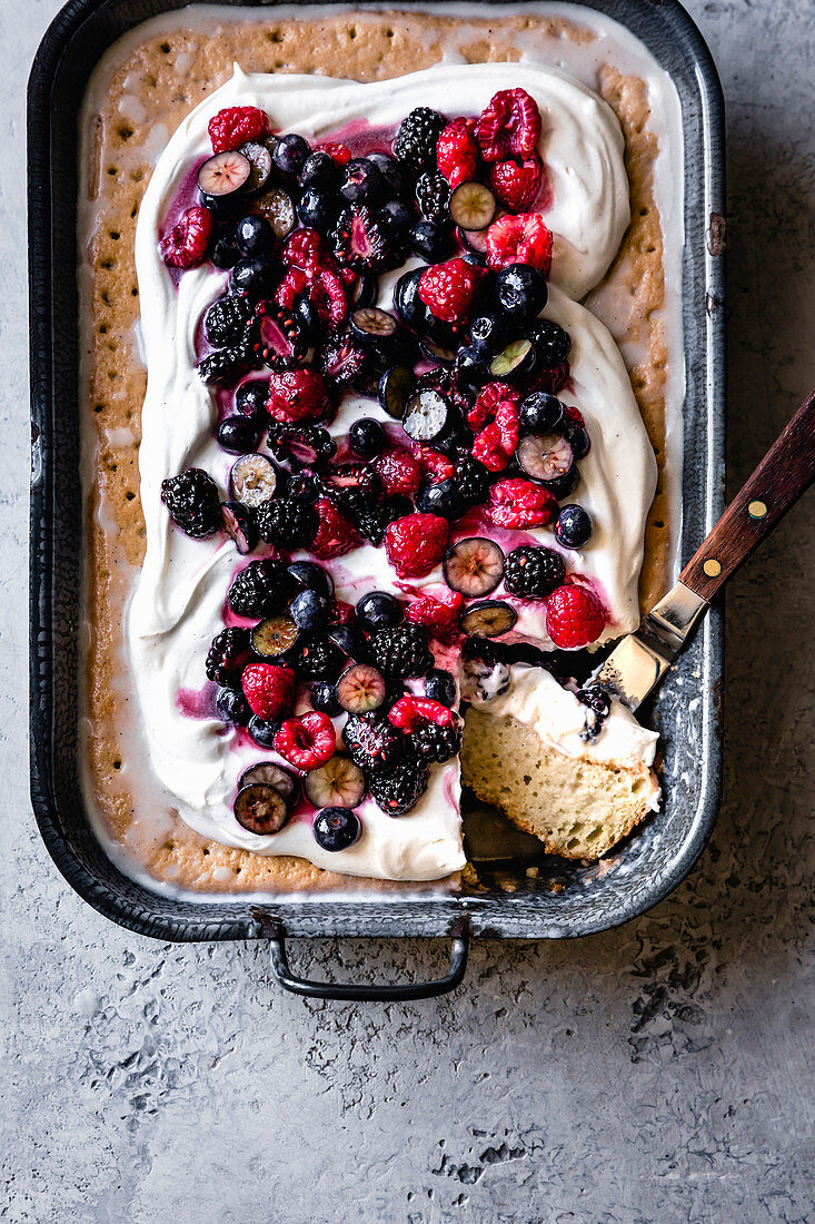 Berry tres leches cake in a baking dish