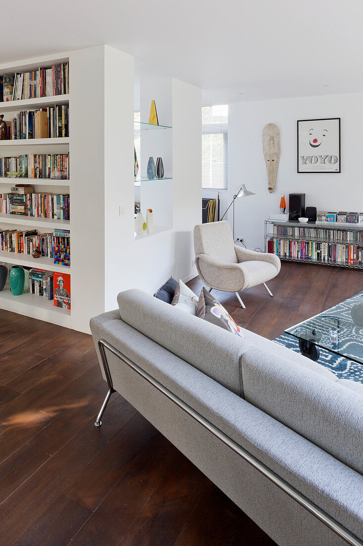 Bookcase and lounge area in open-plan interior