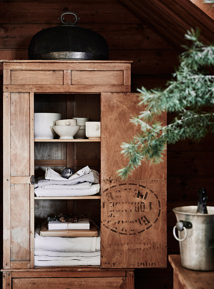 Wooden crockery cupboard with open door