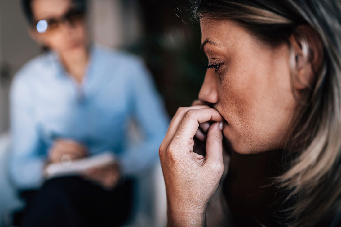 Woman with anxiety talking to mental health professional