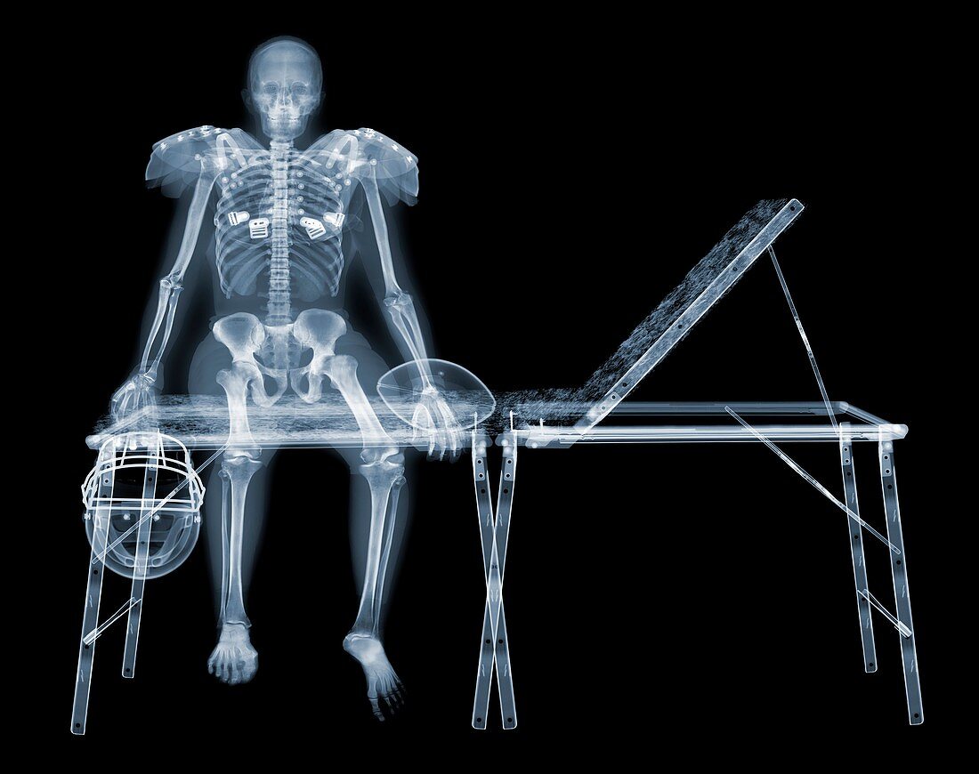 Skeleton of American footballer on sports couch, X-ray