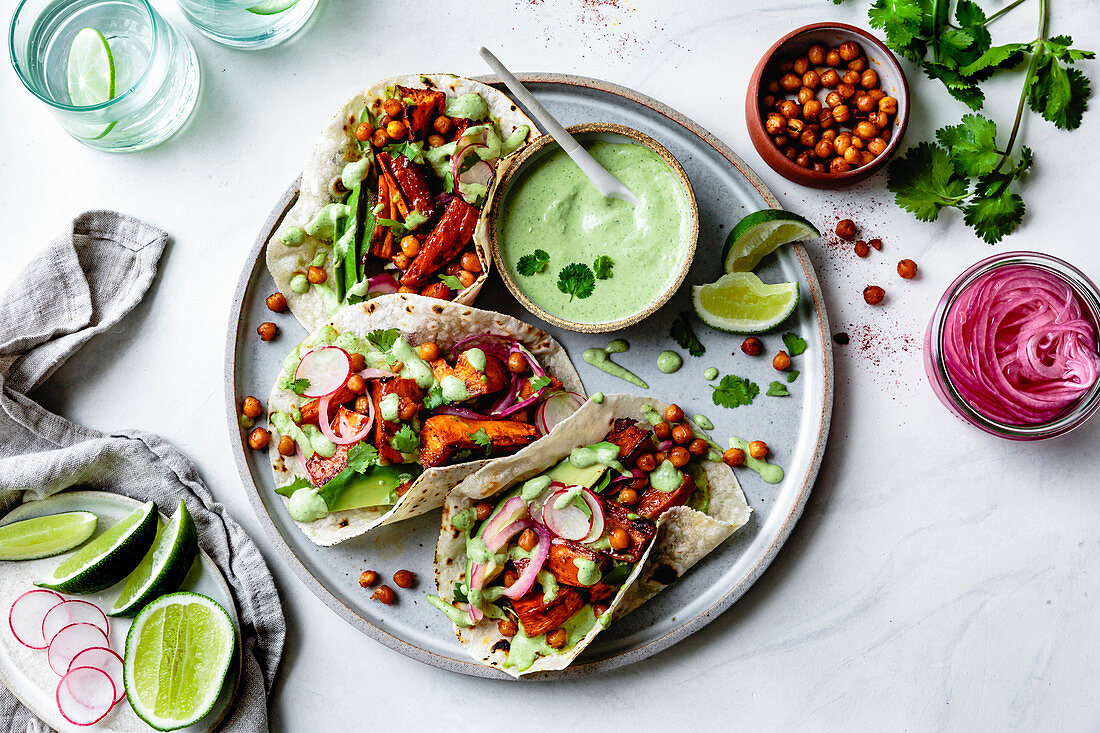 Sweet potato chickpea tacos with cilantro crema on a plate
