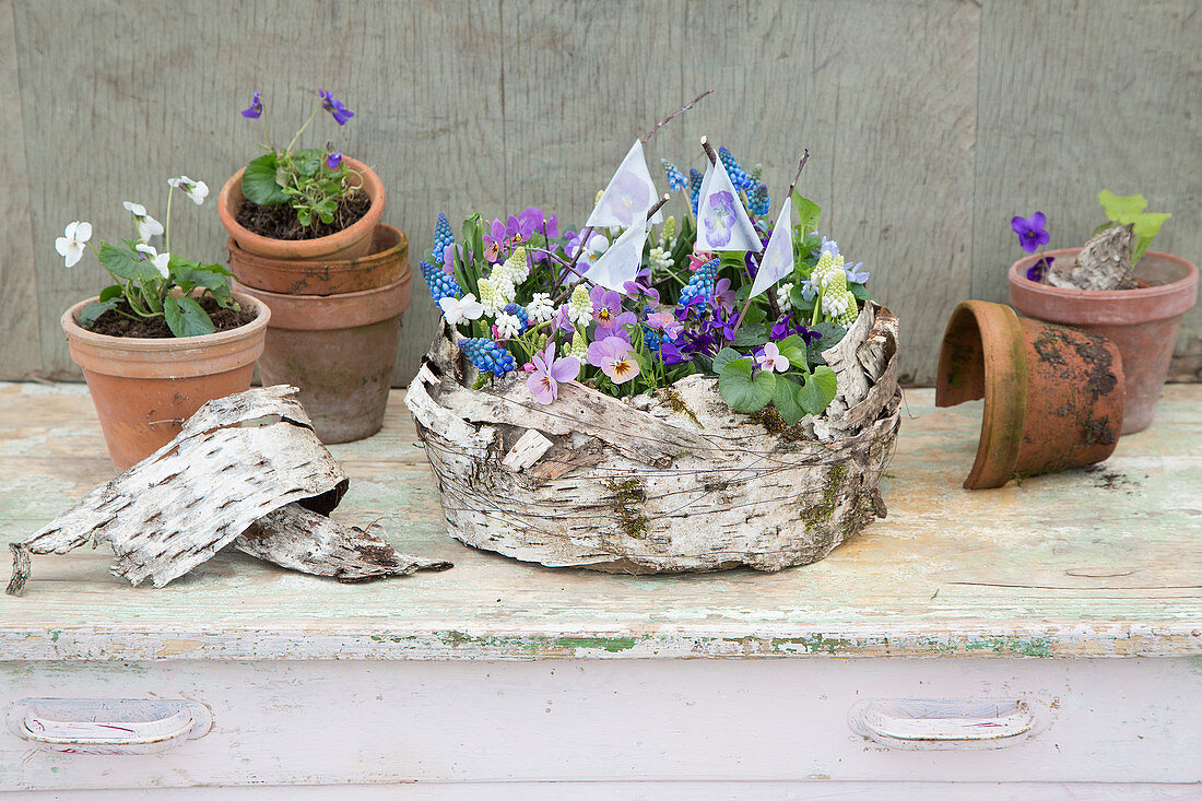 Spring flower arrangement decorated with birch bark